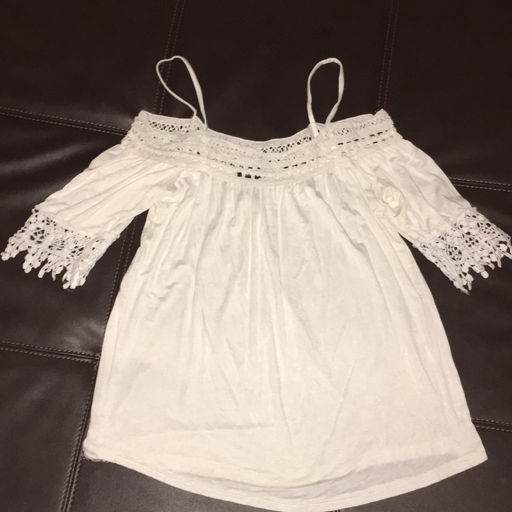 Cream colored adorable top with crochet detail.